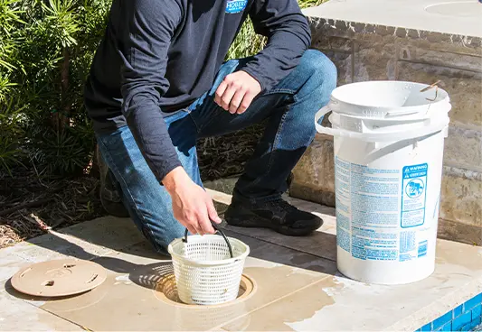 A Hobert technician servicing a pool skimmer.